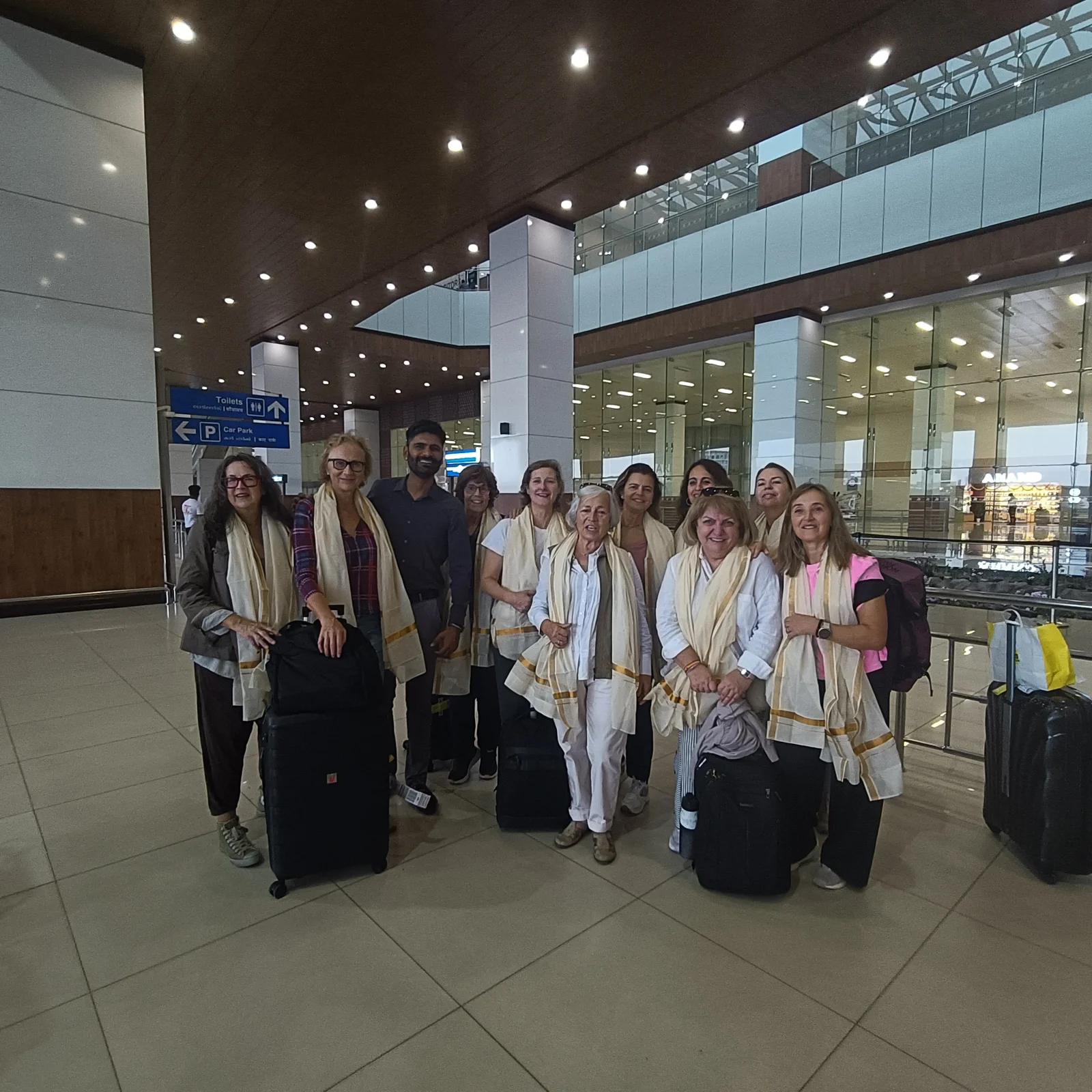 Guests arriving at Cochin Airport wearing traditional Kerala kasavu stoles